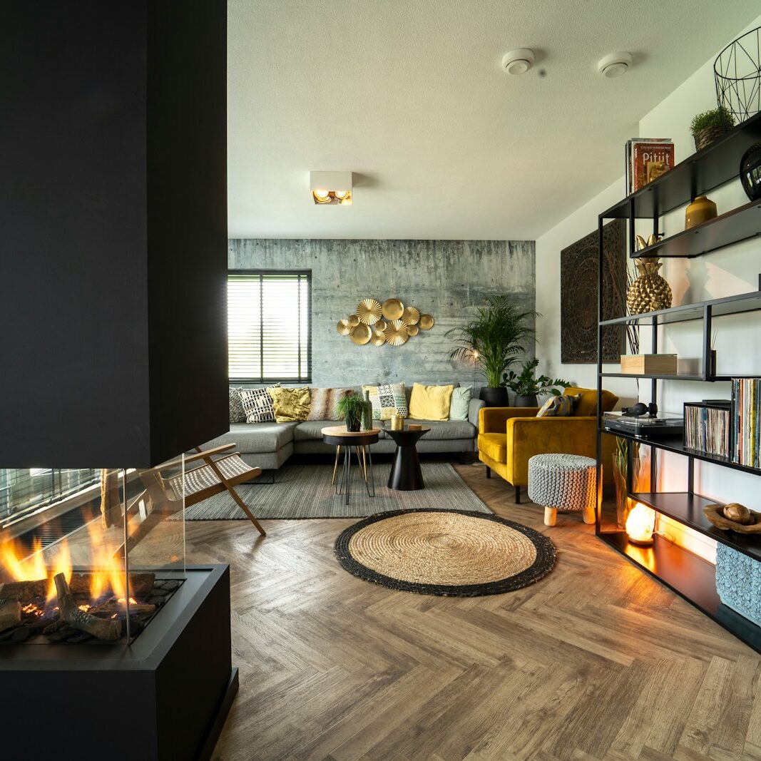 Photo by Robin van Geenen black fireplace near black flat screen tv